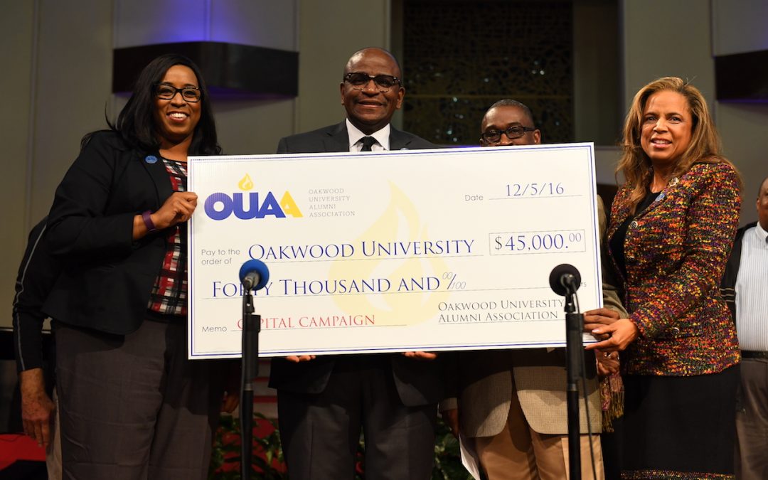 A check from representatives of the Oakwood University Alumni Association